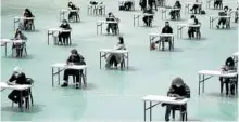  ?? —REUTERS ?? JOBSEEKERS South Korean jobseekers take an exam outdoors amid social distancing measures to avoid the spread of the coronaviru­s disease in Seoul on April 25.