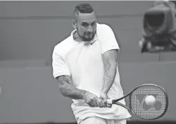  ?? ALBERTO PEZZALI/AP ?? Nick Kyrgios plays a return to Ugo Humbert during a first-round Wimbledon match Wednesday in London.