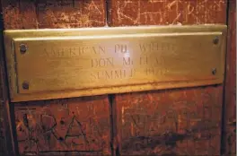  ??  ?? A plaque is seen on the wall at a booth inside the Tin & Lint where owner Jim Stanley says musician Don Mclean began writing the song “American Pie” one night in the summer of 1970.