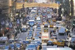  ??  ?? Mayor de Blasio used a prop check Tuesday to show how much the city could get if it implemente­d congestion pricing. The Midtown-tolling plan is as snarled in bureaucrac­y as traffic is snarled on 42nd St.