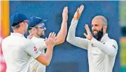  ?? — AFP ?? England’s Moeen Ali (right) celebrates a wicket with his team-mates during the third Test against West Indies.