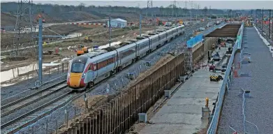  ?? JOHN RUDD. ?? Looking north from the top of the southern ramp at Werrington on January 16, LNER 800113 is diverted around the worksite on the Stamford Lines with a service from Inverness to London King’s Cross. The three running lines of the ECML will be blocked for the next nine days and are in the process of being removed by NR’s ‘Orange Army’.