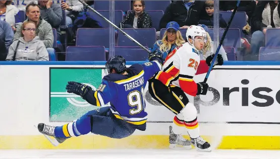  ?? BILLY HURST/ASSOCIATED PRESS ?? Blues forward Vladimir Tarasenko goes crashing into the boards after colliding with Calgary’s Dillon Dube in a 5-3 Blues win Thursday night in St. Louis.