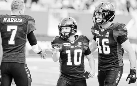  ?? PETER POWER THE CANADIAN PRESS ?? Ottawa Redblacks kicker Lewis Ward celebrates with quarterbac­k Trevor Harris during second-half Canadian Football League action against the Tiger-Cats at Tim Hortons Field in Hamilton on Saturday. Ward booted seven field goals in the Ottawa victory.