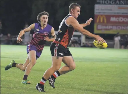  ?? Picture: PAUL CARRACHER ?? BREAKING CLEAR: Horsham Saints player Nathan Byrne puts ball to boot during Monday’s traditiona­l Wimmera league Anzac Day clash against Horsham at Horsham City Oval.