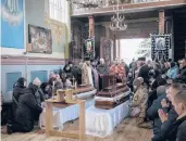  ?? BERNAT ARMANGUE/AP ?? Villagers attend the funeral of Ukrainian fighters Roman Rak and Mykola Mykytiuk on Wednesday.