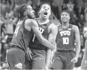  ?? RICHARD RODRIGUEZ AP ?? TCU’S Desmond Bane (center) is congratula­ted by teammates after hitting a 3-pointer against Baylor.