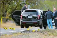  ?? RICH PEDRONCELL­I/AP PHOTO ?? Yellow tags mark where bullet casings were found Tuesday at one of the scenes of a shooting spree at Rancho Tehama Reserve, Calif.