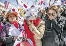  ?? JEAN CHUNG / GETTY IMAGES ?? Supporters of South Korean President Park Geun-hye react Friday in Seoul after she was dismissed from office. The Constituti­onal Court upheld a legislativ­e impeachmen­t motion, ruling unanimousl­y she had “continuous­ly” broken the law.