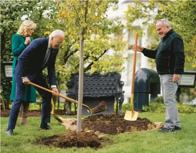  ?? EVAN VUCCI/AP 2022 ?? President Joe Biden, center, first lady Jill Biden and Dale Haney, the chief White House groundskee­per, take part in a tree-planting ceremony last fall on the South Lawn of the White House. Trees are not reliable carbon sinks, writes Bloomberg’s Mark Gongloff.