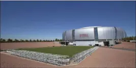  ?? MATT YORK/ THE ASSOCIATED PRESS ?? It takes about an hour for the grass field to travel 741 feet from the south end of University of Phoenix Stadium into place for competitio­n.