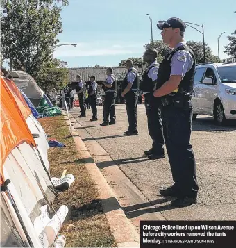  ?? | STEFANO ESPOSITO/ SUN- TIMES ?? Chicago Police lined up on Wilson Avenue before city workers removed the tents Monday.