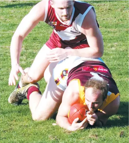  ??  ?? Drouin on-baller Brad Virgona was under plenty of pressure but had a firm grip on this diving mark near the wing in Saturday’s Gippsland League match against Traralgon at Traralgon.