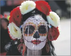  ?? FERNANDO LLANO/AP ?? A WOMAN MADE UP AS A “CATRINA” and wearing a face shield posed for a photo during Day of the Dead festivitie­s in Mexico City, Sunday.