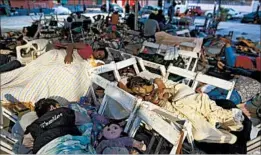  ?? REBECCA BLACKWELL/AP ?? Juchitan residents sleep Sunday morning after their third night at an outdoor shelter.