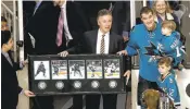  ?? JOSIE LEPE/STAFF ?? The Sharks’Patrick Marleau, right, with his sons, accepts a plaque listing his milestones­Wednesday from GM Doug Wilson. Marleau recently scored his 500th goal.