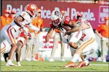  ?? ?? North Carolina State’s Devin Carter (88) is tied up by Clemson’s Tyler Venables (12) and Clemson’s Tre Williams (8) during the first half of an NCAA college football game in Raleigh, N.C., on Sept. 25. (AP)