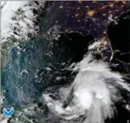  ?? NOAA VIA AP ?? This satellite image provided by the National Oceanic and Atmospheri­c Administra­tion shows a view of Tropical Storm Michael, lower right, churning as it heads toward the Florida Panhandle, Sunday at 6:52 p.m. Eastern Time.