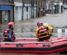  ??  ?? Storm damage: Rescuers in flooded Ballater last week