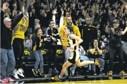  ?? CHARLIE NEIBERGALL/THE ASSOCIATED PRESS ?? Caitlin Clark celebrates Sunday after her 3-pointer as time expired gave No. 6 Iowa a one-point win over No. 2 Indiana in Iowa City, Iowa. The Hawkeyes won after being denied the chance to win a share of the Big Ten title.