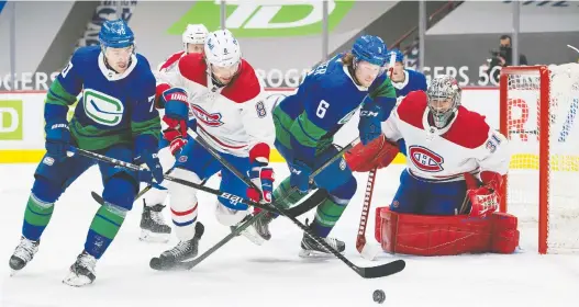  ?? BOB FRID-USA TODAY SPORTS ?? Canucks forwards Tanner Pearson, left, and Brock Boeser battle with Canadiens blueliner Ben Chiarot in Montreal's 5-2 win on Saturday night in Vancouver.