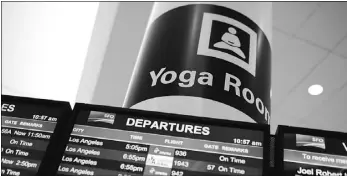  ?? Justin Sullivan, Getty Images ?? A sign is posted near the departures monitor for the new yoga room at San Francisco
Internatio­nal Airport.