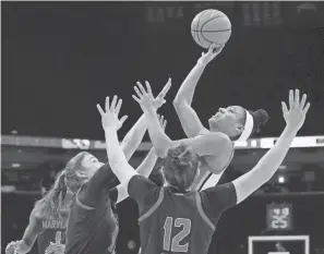  ?? BARBARA J. PERENIC/COLUMBUS DISPATCH ?? Ohio State's Taylor Thierry is guarded by Maryland's Abby Meyers (10) and Elisa Pinzan.