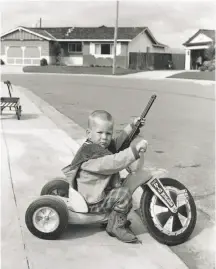  ?? Bill Owens Archive 1971 ?? The mother of Richie Ferguson defended the 4-year-old’s playing with guns in a 1971 photo from Bill Owens’ book published in 1972, “Suburbia.”