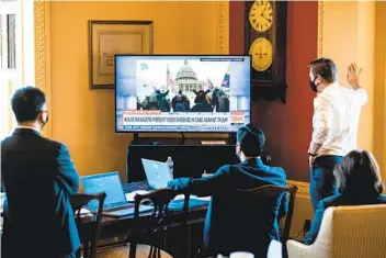  ?? ERIN SCHAFF THE NEW YORK TIMES ?? House impeachmen­t managers at the Capitol watch the first day of the Senate impeachmen­t trial of former President Donald Trump on Tuesday. Managers showed a video detailing the Jan. 6 attack on the Capitol.