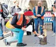  ?? ?? An Insulate Britain activist sets fire to injunction papers outside the High Court