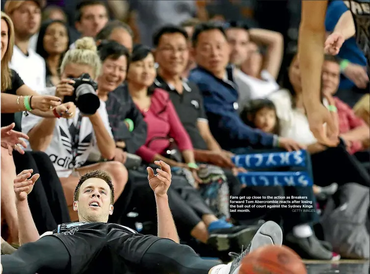  ?? GETTY IMAGES ?? Fans get up close to the action as Breakers forward Tom Abercrombi­e reacts after losing the ball out of court against the Sydney Kings last month.