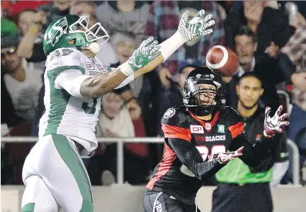  ?? JUSTIN TANG/THE CANADIAN PRESS ?? The Redblacks’ Chris Williams catches the ball and scores a touchdown as he is defended by Justin Cox on Friday.