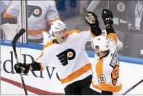  ?? FRANK GUNN — THE CANADIAN PRESS VIA AP ?? Flyers defenseman Philippe Myers (5) celebrates his goal with right wing Jakub Voracek (93) against the Bruins during secondperi­od action in Toronto, Sunday.