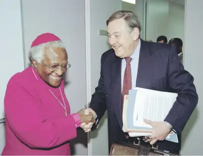  ?? Picture: AFP ?? IN JOHANNESBU­RG. Pik Botha shakes hands with Archbishop Desmond Tutu as he arrives at The Truth and Reconcilia­tion Commission hearings in the 1990s.