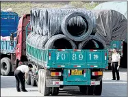  ?? AP ?? Chinese customs officials inspect trucks loaded with goods headed to and from North Korea on Monday in Dandong, northeaste­rn China.