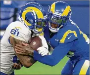  ??  ?? Los Angeles Rams cornerback Jalen Ramsey (right) tackles tight end Gerald Everett during practice Saturday in Inglewood, Calif. The Rams are scrimmagin­g at the stadium on the next two Saturdays.