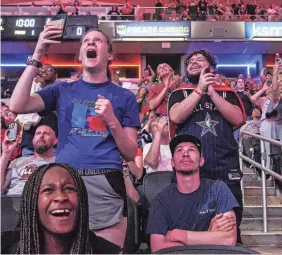  ?? MICHELLE PEMBERTON/THE INDIANAPOL­IS STAR ?? Fever fans celebrate the No. 1 overall pick of Caitlin Clark during a draft party at Gainbridge Fieldhouse in Indianapol­is.