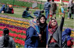  ?? — PTI ?? Visitors take a selfie at the Indira Gandhi Memorial Tulip Garden, believed to be Asia’s largest, in Srinagar on Sunday.