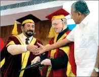  ??  ?? DEEPER TIES: Dr Sheikh Sultan being congratula­ted by Kerala Chief Minister Pinarayi Vijayan after being conferred a doctorate in Thiruvanan­thapuram on Tuesday