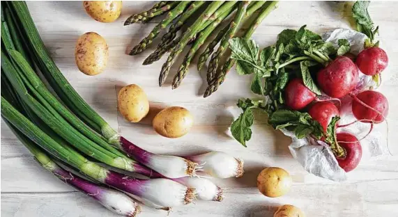  ?? Stacy Zarin Goldberg / For the Washington Post; food styling by Lisa Cherkasky /For the Washington Post ?? Shake off the heavy tastes of winter with spring onions and ramps, new potatoes, asparagus and radishes.
