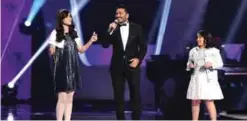  ??  ?? Egyptian singer and judge Tamer Hosny (center) sings with Iraqi Nour Wissam (left) and Egyptian Achrakat Ahmad (right) during season two of the “The Voice Kids: Ahla Sawt”.