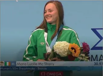  ??  ?? Mona McSharry receiving a Bronze medal in the 50m Breaststro­ke at the World Junior Championsh­ips.