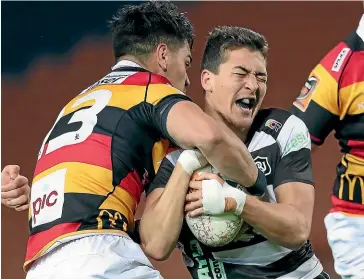  ?? GETTY IMAGES ?? Hawke’s Bay’s Tiaan Falcon runs into the strong defence of Quinn Tupaea during the Ranfurly Shield challenge in Hamilton last night, won by Waikato.