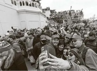  ?? Jessica Griffin / Tribune News Service ?? Pro-donald Trump supporters swarm outside the Capitol following a “Stop the Steal” rally. Some rioters breached the building, forcing members of Congress and others to flee.