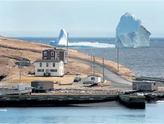  ?? PAUL DALY/CP FILES ?? A large iceberg is visible from the shore in Ferryland, an hour south of St. John’s, earlier this month.