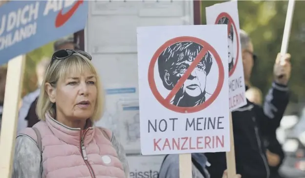  ?? PICTURE: GETTY ?? Supporters of the right-wing Alternativ­e for Germany political party demonstrat­e against Merkel’s Christian Democratic Union party