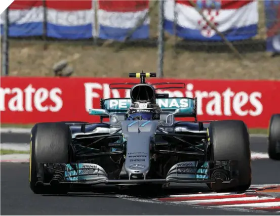  ??  ?? Above and Right Bottas held up Hamilton (in the yellow helmet) before letting the Brit through. Hamilton reversed the order in the last corner of the race, so that Bottas could celebrate on the podium (right).Top Right The podium was a red affair, with the Ferrari drivers first and second – or was it a Finnish affair, with Räikkönen and Bottas second and third?Middle Right Verstappen blasts out of the pits after a 10 second stop-and-go penalty for taking his team mate out on the first lap.