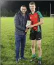  ??  ?? Brendan Lawrence presents Conor Reid with the Wicklow People Man of the Match award.