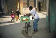  ?? Ramon Espinosa / Associated Press ?? A pastry vendor waits for customers in Havana. Currently, there are 535,000 self-employed Cubans.