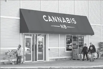  ??  ?? Shoppers, heading from a nearby grocery store, walk past one of two Cannabis NB locations in Saint John, N.B., on Oct.14.